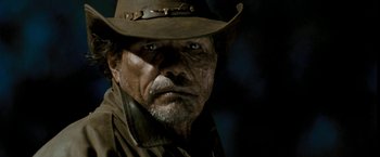 Movie still from “Red Hill” (2010), directed by Patrick Hughes – An older man wearing a hat and a brown jacket; Close Up shot, Over the shoulder angle