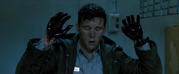 Movie still from “Red Hill” (2010), directed by Patrick Hughes – A man with blood all over his face and hands; Close Up shot, High angle