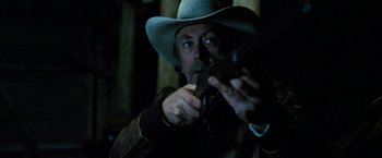 Movie still from “Red Hill” (2010), directed by Patrick Hughes – A man in a cowboy hat is holding a gun; Close Up shot, Low angle