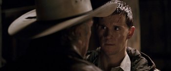 Movie still from “Red Hill” (2010), directed by Patrick Hughes – A man wearing a cowboy hat looking at another man; Close Up shot, Over the shoulder angle