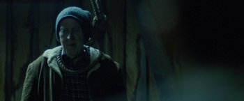 Movie still from “Red Hill” (2010), directed by Patrick Hughes – A man hanging from a rope in a dark room; Close Up shot, Over the shoulder angle
