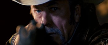 Movie still from “Red Hill” (2010), directed by Patrick Hughes – An older man with a hat on; Extreme Close Up shot, Over the shoulder angle