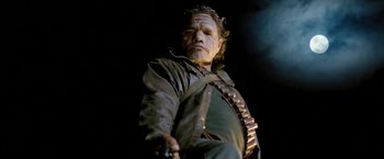 Movie still from “Red Hill” (2010), directed by Patrick Hughes – A man in a leather jacket holding a gun; Medium shot, Low angle