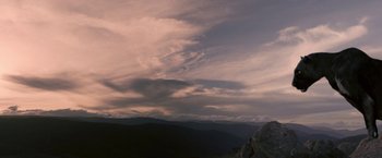 Movie still from “Red Hill” (2010), directed by Patrick Hughes – A view of a mountain range with clouds in the sky at dusk; Extreme Wide shot, Low angle
