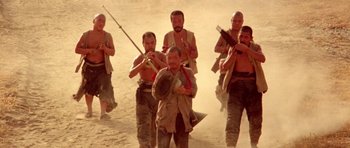 Movie still from “Red Sorghum” (1988), directed by Yimou Zhang – A group of men standing on top of a dirt field; Wide shot, Low angle