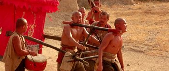 Movie still from “Red Sorghum” (1988), directed by Yimou Zhang – A group of men are fighting with wooden sticks; Medium shot, Low angle