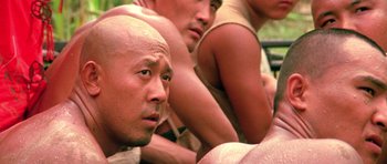 Movie still from “Red Sorghum” (1988), directed by Yimou Zhang – A group of men sitting next to each other; Close Up shot, Over the shoulder angle