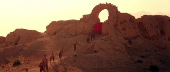 Movie still from “Red Sorghum” (1988), directed by Yimou Zhang – A group of people standing on top of a rock formation; Extreme Wide shot, Low angle