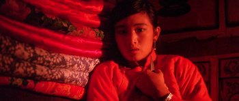 Movie still from “Red Sorghum” (1988), directed by Yimou Zhang – A woman in a red jacket is lying on the ground; Close Up shot, High angle