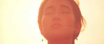 Movie still from “Red Sorghum” (1988), directed by Yimou Zhang – A person with their eyes closed; Extreme Close Up shot, Low angle