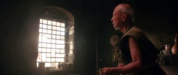 Movie still from “Red Sorghum” (1988), directed by Yimou Zhang – An older man standing in front of a window; Medium shot, Low angle