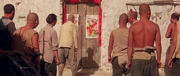Movie still from “Red Sorghum” (1988), directed by Yimou Zhang – A group of men standing in front of a door; Wide shot, Low angle