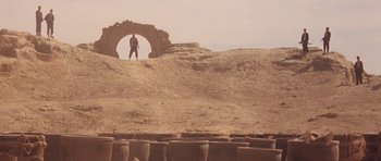 Movie still from “Red Sorghum” (1988), directed by Yimou Zhang – A man standing on top of a dirt hill; Extreme Wide shot, Low angle