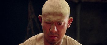 Movie still from “Red Sorghum” (1988), directed by Yimou Zhang – A bald man with a shaved head and no hair; Close Up shot, High angle