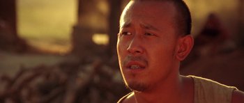 Movie still from “Red Sorghum” (1988), directed by Yimou Zhang – A person with his eyes closed; Close Up shot, Low angle