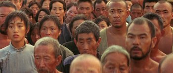 Movie still from “Red Sorghum” (1988), directed by Yimou Zhang – A large group of people standing in a room; Medium shot, High angle