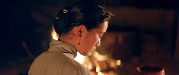 Movie still from “Red Sorghum” (1988), directed by Yimou Zhang – A woman is looking down at her face; Close Up shot, Over the shoulder angle