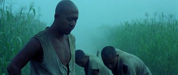 Movie still from “Red Sorghum” (1988), directed by Yimou Zhang – A group of men standing next to each other on top of a hill; Medium shot, Low angle