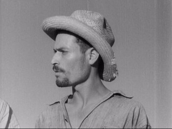Movie still from “Redes” (1936), directed by Fred Zinnemann – A black and white photo of a man wearing a straw hat; Close Up shot, Low angle