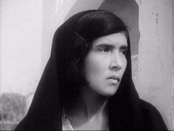 Movie still from “Redes” (1936), directed by Fred Zinnemann – A young woman wearing a black headscarf and looking to her left; Close Up shot, Low angle