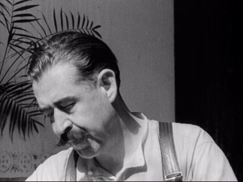 Movie still from “Redes” (1936), directed by Fred Zinnemann – A black - and - white photo of a man smoking a cigarette; Close Up shot, Low angle