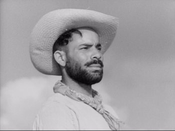 Movie still from “Redes” (1936), directed by Fred Zinnemann – A man wearing a cowboy hat and a neck tie; Close Up shot, Low angle