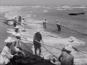 Movie still from “Redes” (1936), directed by Fred Zinnemann – A black and white photo of a group of people in the water; Wide shot, High angle