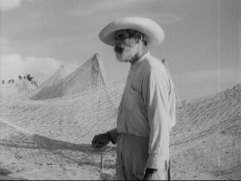 Movie still from “Redes” (1936), directed by Fred Zinnemann – An older man wearing a hat standing in the desert; Medium shot, Low angle