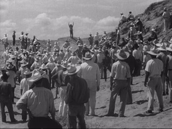 Movie still from “Redes” (1936), directed by Fred Zinnemann – A large group of men in hats and white shirts; Extreme Wide shot, High angle
