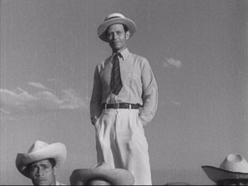 Movie still from “Redes” (1936), directed by Fred Zinnemann – An old photo of a man wearing a hat and a tie; Medium shot, Low angle