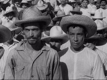 Movie still from “Redes” (1936), directed by Fred Zinnemann – A black and white photo of two men wearing hats; Medium shot, High angle