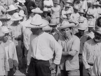 Movie still from “Redes” (1936), directed by Fred Zinnemann – A black and white photo of a group of men wearing hats; Medium shot, High angle