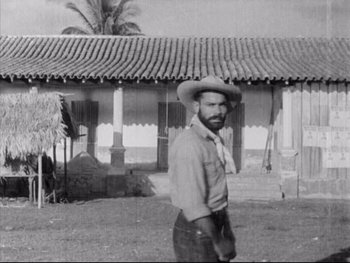 Movie still from “Redes” (1936), directed by Fred Zinnemann – An old photo of a man wearing a cowboy hat; Wide shot, High angle