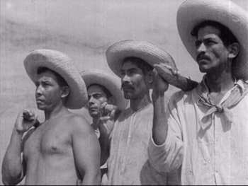 Movie still from “Redes” (1936), directed by Fred Zinnemann – A black and white photo of a group of men wearing hats; Medium shot, Low angle