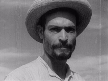 Movie still from “Redes” (1936), directed by Fred Zinnemann – A black and white photo of a man wearing a straw hat; Close Up shot, High angle