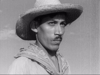 Movie still from “Redes” (1936), directed by Fred Zinnemann – A man wearing a straw hat and a bandana; Close Up shot, Low angle