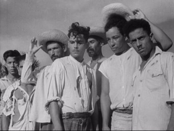 Movie still from “Redes” (1936), directed by Fred Zinnemann – A black and white photo of a group of men in straw hats; Medium shot, Low angle