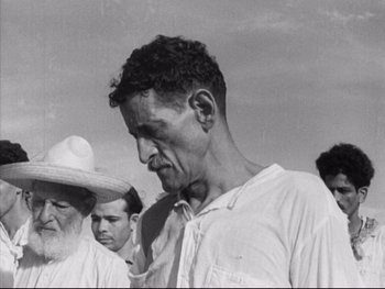 Movie still from “Redes” (1936), directed by Fred Zinnemann – An old black and white photo of a group of men; Close Up shot, High angle
