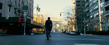 Movie still from “Reign Over Me” (2007), directed by Mike Binder – A man riding a skateboard down the middle of a street; Wide shot, Low angle