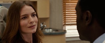 Movie still from “Reign Over Me” (2007), directed by Mike Binder – A person smiling in a room; Close Up shot, Over the shoulder angle