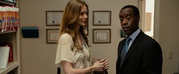 Movie still from “Reign Over Me” (2007), directed by Mike Binder – A woman standing next to a man in a suit; Medium shot, Over the shoulder angle