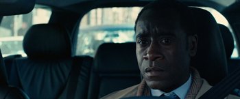 Movie still from “Reign Over Me” (2007), directed by Mike Binder – A person sitting in a car looking at the camera; Close Up shot, Over the shoulder angle