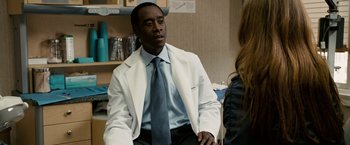 Movie still from “Reign Over Me” (2007), directed by Mike Binder – A man wearing a white lab coat and a blue tie; Medium shot, Over the shoulder angle