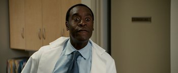 Movie still from “Reign Over Me” (2007), directed by Mike Binder – A man in a white lab coat and a tie; Close Up shot, Low angle