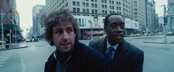 Movie still from “Reign Over Me” (2007), directed by Mike Binder – Two men in business suits standing in front of a building; Close Up shot, Over the shoulder angle