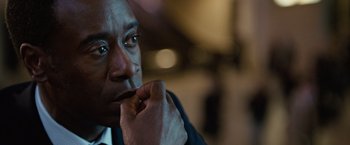 Movie still from “Reign Over Me” (2007), directed by Mike Binder – A person with his hand to his face; Close Up shot, Over the shoulder angle