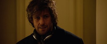 Movie still from “Reign Over Me” (2007), directed by Mike Binder – A person wearing headphones and a jacket; Close Up shot, Over the shoulder angle