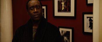 Movie still from “Reign Over Me” (2007), directed by Mike Binder – A man standing in front of a group of pictures; Close Up shot, Over the shoulder angle