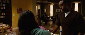 Movie still from “Reign Over Me” (2007), directed by Mike Binder – A man and a woman are sitting in a living room; Medium shot, Over the shoulder angle