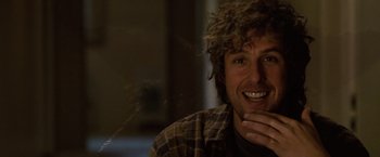 Movie still from “Reign Over Me” (2007), directed by Mike Binder – A person with curly hair smiling; Close Up shot, Over the shoulder angle